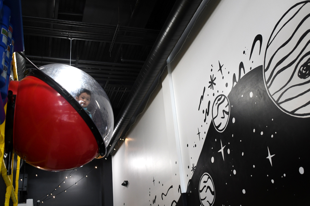 Kid-in-space-capsule-at-outer-space-indoor-play-space-west-seattle